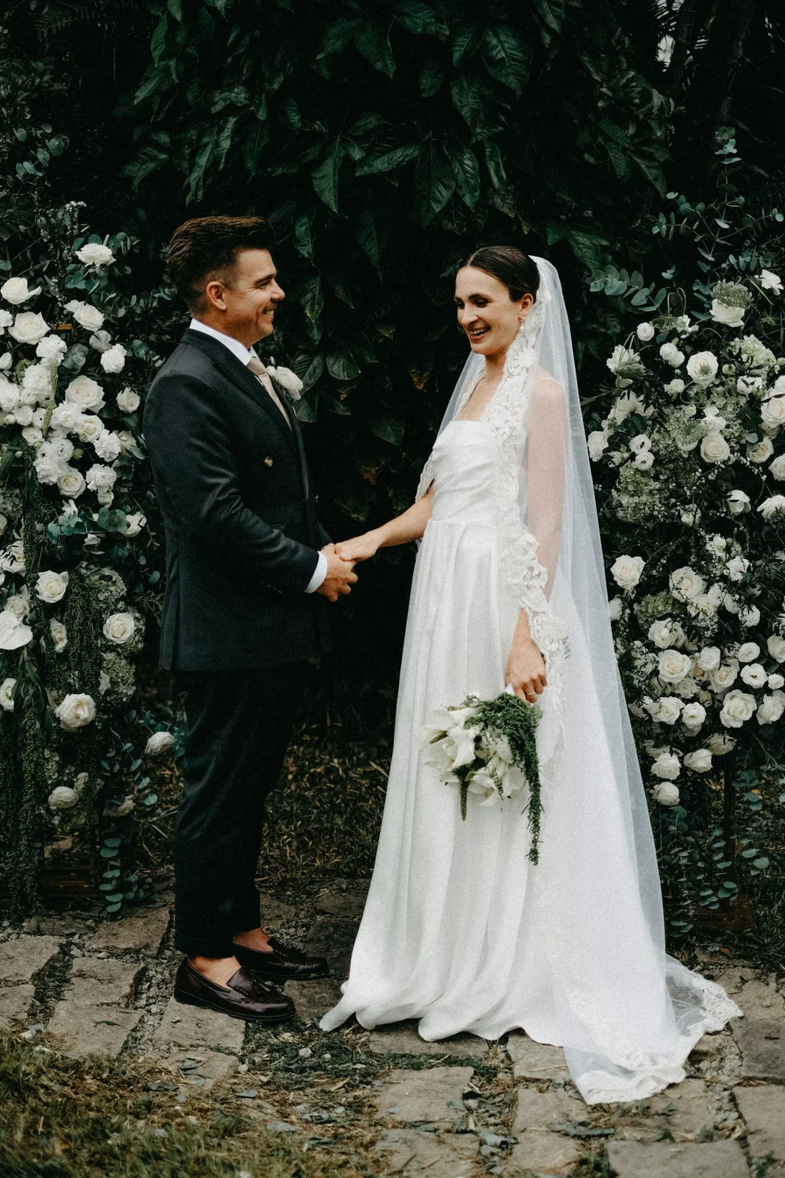 A couple holding hands in a garden